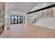Open-concept living room with sliding glass doors, wood floors, and staircase with wood and black metal railings at 804 Spyglass Cir, Louisville, CO 80027