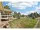 Expansive backyard features a well-maintained lawn, mature trees, and views of rolling hills at 2287 Pinto Trl, Elizabeth, CO 80107