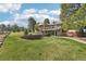 Beautiful home exterior featuring a spacious backyard with lush green lawn and a charming covered deck at 2287 Pinto Trl, Elizabeth, CO 80107