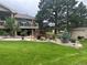 Spacious backyard features lush lawn, mature trees, and a patio, creating a tranquil outdoor retreat at 2287 Pinto Trl, Elizabeth, CO 80107