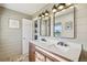 Elegant bathroom with double sink vanity, modern fixtures, and shiplap wall paneling at 2287 Pinto Trl, Elizabeth, CO 80107