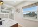 Bright bathroom featuring double vanity, a walk-in shower, and a scenic window view at 2287 Pinto Trl, Elizabeth, CO 80107