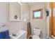 Compact powder room with a pedestal sink, decorative mirror and rustic accents at 2287 Pinto Trl, Elizabeth, CO 80107