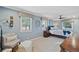Comfortable bedroom with light blue walls, large windows, and ceiling fan at 2287 Pinto Trl, Elizabeth, CO 80107