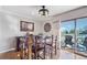 A formal dining area features wood floors, wooden furniture, access to the deck, and a ceiling fan at 2287 Pinto Trl, Elizabeth, CO 80107