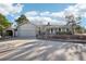 Front exterior showing the home with attached garage, secondary outbuilding, driveway and brickwork landscaping at 2287 Pinto Trl, Elizabeth, CO 80107