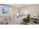 Bright home office featuring a large window, white desk, and comfortable decor at 2287 Pinto Trl, Elizabeth, CO 80107