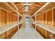Inside storage space with wooden shelving, providing ample room for organizing equipment and materials at 2287 Pinto Trl, Elizabeth, CO 80107