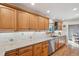 A spacious kitchen featuring wood cabinets, granite counters, stainless steel appliances, and tile backsplash at 2287 Pinto Trl, Elizabeth, CO 80107