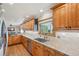 A bright kitchen featuring stainless steel appliances, wood cabinets, granite counters, and tile backsplash at 2287 Pinto Trl, Elizabeth, CO 80107