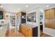 Open kitchen featuring wood cabinets, stainless steel appliances, granite counters, and views into the Gathering room at 2287 Pinto Trl, Elizabeth, CO 80107