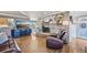 Spacious living room with brick fireplace, stylish furniture, and hardwood floors at 2287 Pinto Trl, Elizabeth, CO 80107