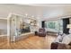 Spacious living room with a brick fireplace, wood floors, and plenty of natural light at 2287 Pinto Trl, Elizabeth, CO 80107