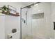 Modern shower with a glass door, white subway tile, and stylish fixtures at 2287 Pinto Trl, Elizabeth, CO 80107