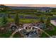 Breathtaking aerial view of a meticulously landscaped property with a fire pit and water features, creating a serene outdoor oasis at 3720 Ranch Hand Ln, Castle Rock, CO 80104
