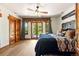 Bright bedroom with hardwood floors, wood trim, and french doors leading to the backyard at 3720 Ranch Hand Ln, Castle Rock, CO 80104