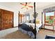 Bedroom with four poster bed, views from the window, and wood trim details at 3720 Ranch Hand Ln, Castle Rock, CO 80104