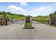 View of the property's main gated entry which includes masonry features and professional landscaping at 3720 Ranch Hand Ln, Castle Rock, CO 80104