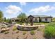 Expansive property featuring a charming fire pit, lush landscaping, and a well-maintained home exterior with a tile roof at 3720 Ranch Hand Ln, Castle Rock, CO 80104