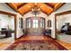 Grand home foyer boasts a wooden ceiling, chandelier, and large wood front door with sidelights at 3720 Ranch Hand Ln, Castle Rock, CO 80104