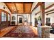 Open foyer with wood beams, chandelier, and stone accents leading into an expansive home at 3720 Ranch Hand Ln, Castle Rock, CO 80104