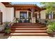 Charming front porch with wood beams, stone accents, and comfortable seating at 3720 Ranch Hand Ln, Castle Rock, CO 80104