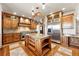 Spacious kitchen featuring custom wood cabinets, a granite island, and stainless steel appliances at 3720 Ranch Hand Ln, Castle Rock, CO 80104
