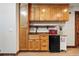 Convenient kitchenette with wood cabinets, a small sink, and a mini fridge at 3720 Ranch Hand Ln, Castle Rock, CO 80104