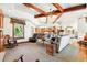 Expansive living room featuring wood beams, fireplace, and an open floor plan at 3720 Ranch Hand Ln, Castle Rock, CO 80104