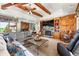 Cozy living room with a stone fireplace, wood beams, and comfortable seating at 3720 Ranch Hand Ln, Castle Rock, CO 80104