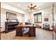 Home office features a custom wood desk, ceiling fan, and a window with outdoor views at 3720 Ranch Hand Ln, Castle Rock, CO 80104