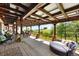Expansive covered patio with lounge seating and dining area, perfect for enjoying the outdoors and entertaining guests at 3720 Ranch Hand Ln, Castle Rock, CO 80104