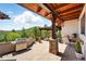 Inviting outdoor patio with a grill, bar seating, and stunning mountain views, perfect for enjoying the serene surroundings at 3720 Ranch Hand Ln, Castle Rock, CO 80104