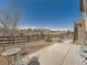 Spacious backyard with a stone patio, a small round table and chairs, and a wooden fence at 23709 E Caleb Pl, Aurora, CO 80016