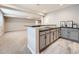 Basement bar area features sleek countertops, gray cabinetry, and opens to a large living area at 23709 E Caleb Pl, Aurora, CO 80016