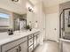 Bathroom featuring a double sink vanity with modern fixtures, and a glass-enclosed shower at 23709 E Caleb Pl, Aurora, CO 80016