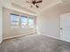 Spacious primary bedroom featuring tray ceiling, carpet, and large windows with natural light at 23709 E Caleb Pl, Aurora, CO 80016