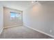 Neutral toned bedroom features carpet, natural light, and large window at 23709 E Caleb Pl, Aurora, CO 80016