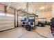 A well lit garage with a camper and a car parked inside of it at 23709 E Caleb Pl, Aurora, CO 80016