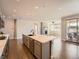 Open concept kitchen area with stainless steel appliances, island with sink, and breakfast bar at 23709 E Caleb Pl, Aurora, CO 80016