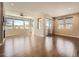 Bright living room featuring hardwood floors, fireplace, recessed lighting, and large windows with neighborhood views at 23709 E Caleb Pl, Aurora, CO 80016