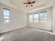 Bright main bedroom with multiple windows offering abundant natural light and neutral-toned carpet at 23709 E Caleb Pl, Aurora, CO 80016