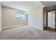 Bright room featuring plush carpeting and a large window for natural lighting at 23709 E Caleb Pl, Aurora, CO 80016