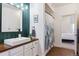 Stylish bathroom featuring a wood vanity, modern vessel sink, and decorative shower curtain at 18669 Stroh Rd # 10208, Parker, CO 80134