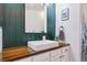 Stylish bathroom featuring a wood vanity, modern vessel sink, and decorative shower curtain at 18669 Stroh Rd # 10208, Parker, CO 80134