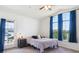 Bright bedroom with a balcony entrance, large windows, and neutral decor at 18669 Stroh Rd # 10208, Parker, CO 80134