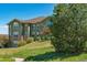 Beautifully landscaped exterior of a multi-story home with green siding and stone accents at 18669 Stroh Rd # 10208, Parker, CO 80134