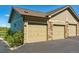 Attached garages with neutral-colored doors, stone accents, and well-maintained landscaping at 18669 Stroh Rd # 10208, Parker, CO 80134