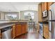 Modern kitchen open to the dining area featuring stainless steel appliances and granite counters at 18669 Stroh Rd # 10208, Parker, CO 80134
