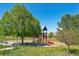 Outdoor playground with colorful slides, climbing structures, and benches under a clear sky at 18669 Stroh Rd # 10208, Parker, CO 80134